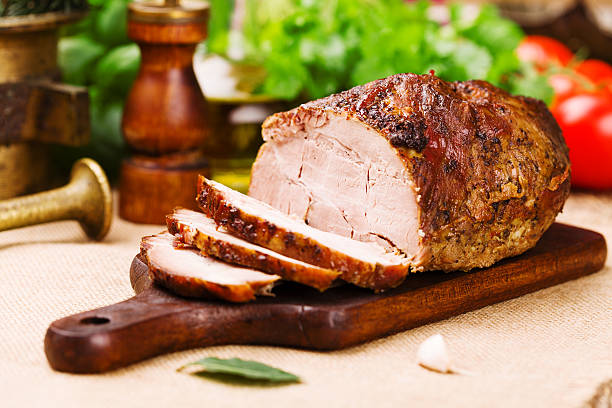 istock Roast pork with herbs and vegetables. 617865330
