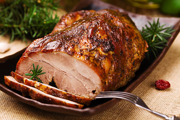 istock Roast pork with herbs and vegetables. 617865436