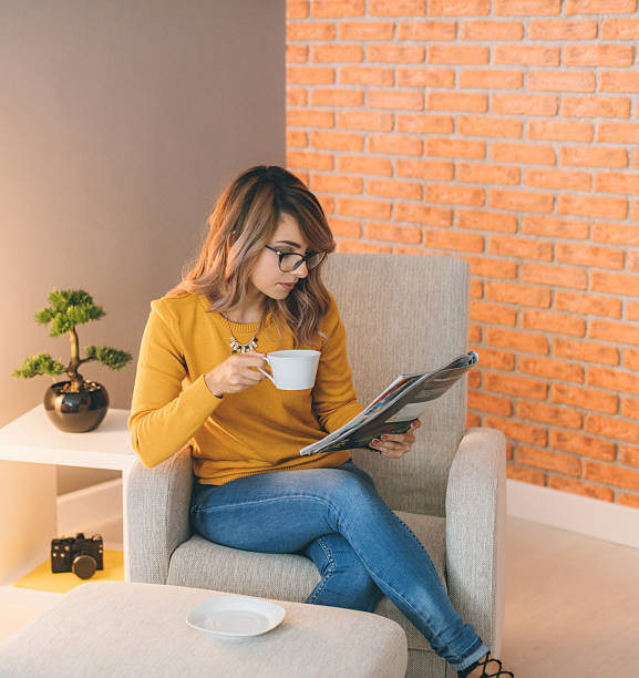 istock Relaxing with magazine and coffee at home 617865870