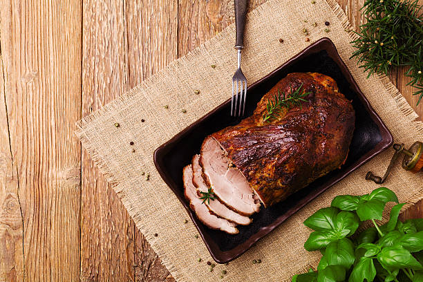 istock Roast pork with herbs and vegetables. 617865906