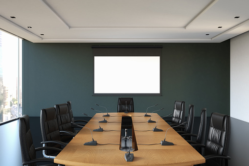Empty boardroom with white screen