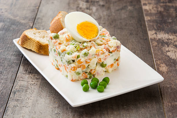 Russian salad on wooden background