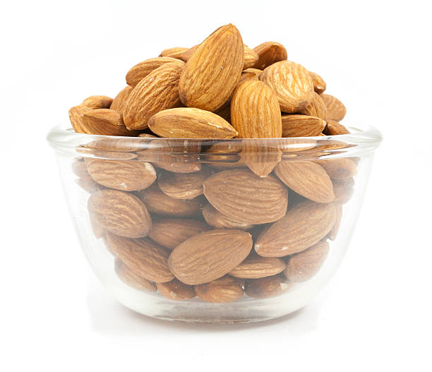 istock bowl wood of almonds isolated 617869626