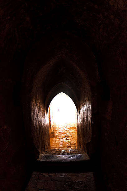 istock The light at long underground brick wall tunnel abstract background 617869964