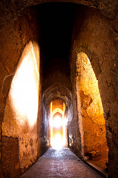 istock The light at long underground brick wall tunnel abstract background 617869972
