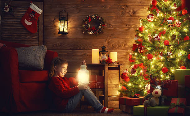 istock girl is decorating the Christmas tree 617871432