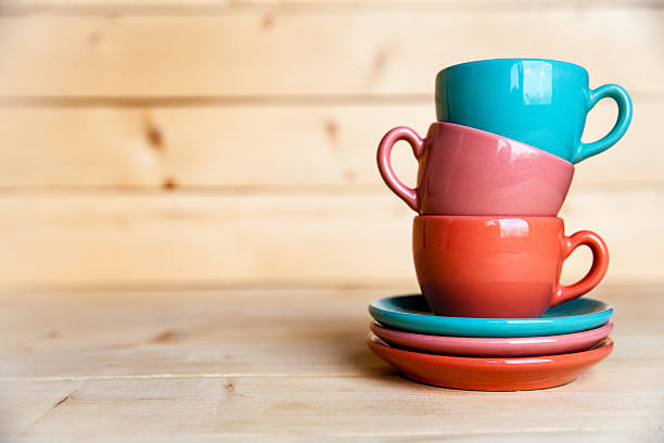 istock Colored cups on the wooden background 617871454