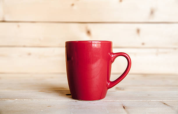 istock Red coffee cup on wooden table 617871700