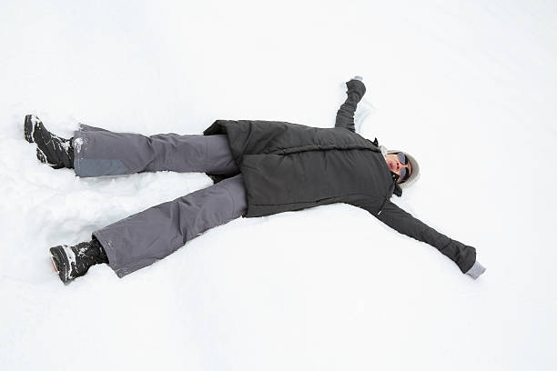 istock young woman lying in snow 617873134