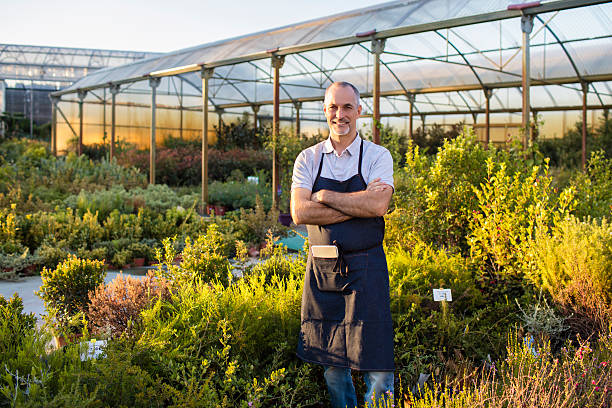Mature man standing outdoors at garden center