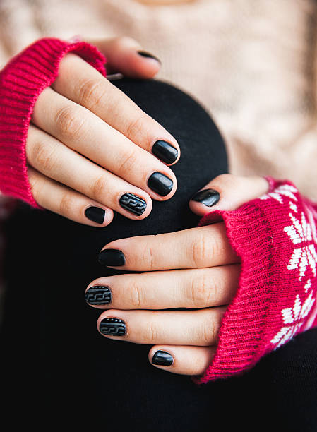 istock Manicure on female hands with black nail polish 617873832