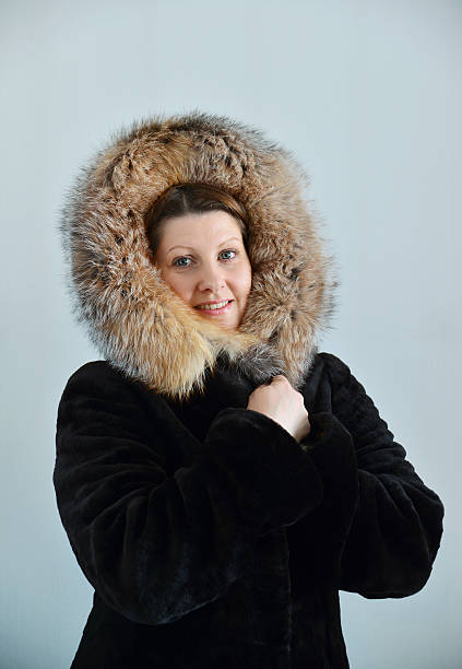 istock woman in a fur coat on  light background 617874416