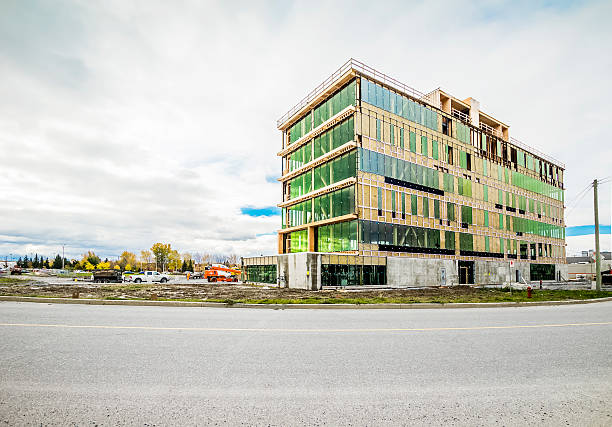 Construction Synergia Complex, LEED Saint-Hyacinthe, Сanada - October 24, 2016: SYNERGIA COMPLEX Built at the corner of Casavant Boulevard and East Johnson Street, Saint-Hyacinthe. The tower at prestigious offices will be built according to strict standards of sustainable development and seeks LEED certification. The building with modern architecture present an apparent wood structure as well as imposing fenestration, allowing access to natural light and great views. saint hyacinthe photos stock pictures, royalty-free photos & images