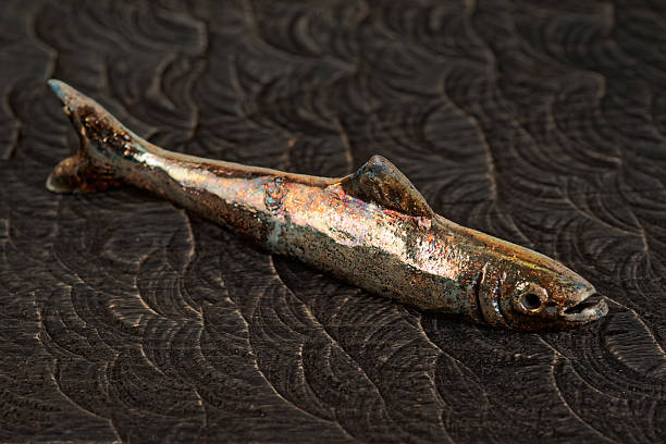 istock Handmade clay fish on wood 617875416