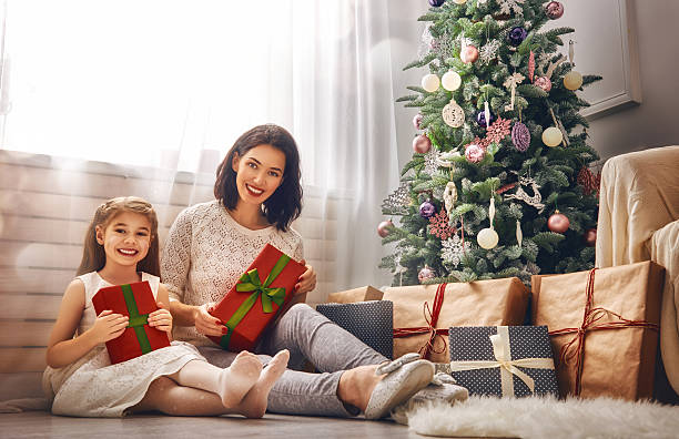 istock Mother and daughter exchanging gifts 617875422