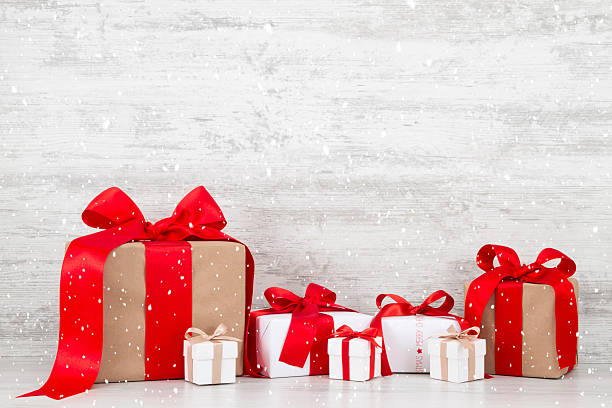 istock Christmas Gift Boxes on White Wooden Background 617876400