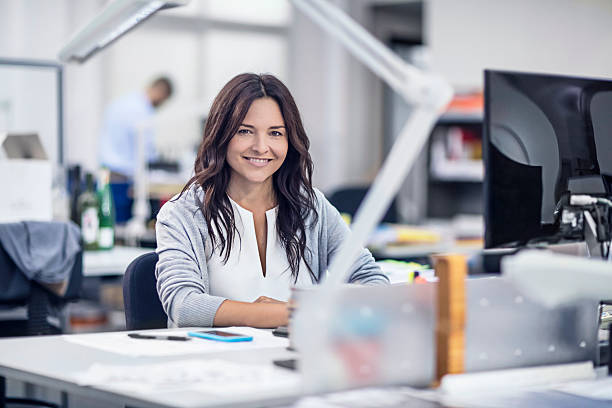 istock Confident businesswoman sitting at her desk 617876996
