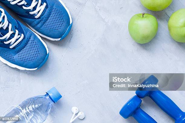 Flat Lay Sport Shoes Dumbbells Earphones Apples Bottle Of Water Stock Photo - Download Image Now