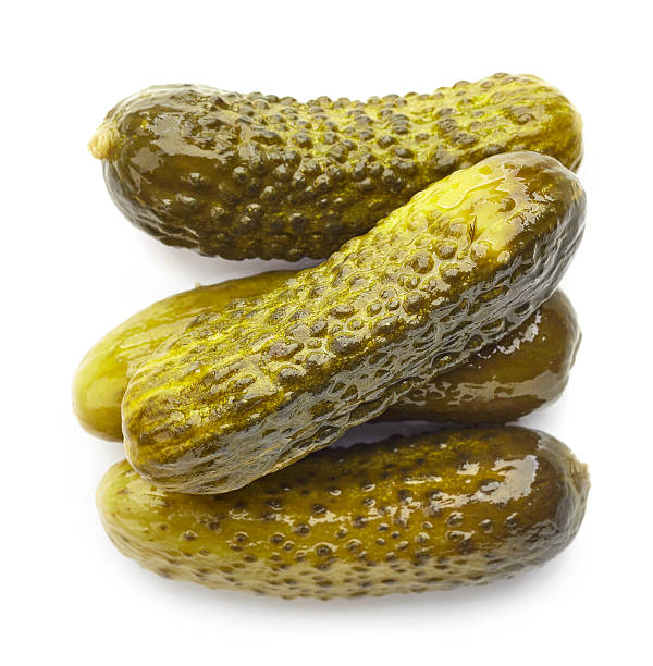 istock Pickled cucumbers isolated on white, from above 617878886