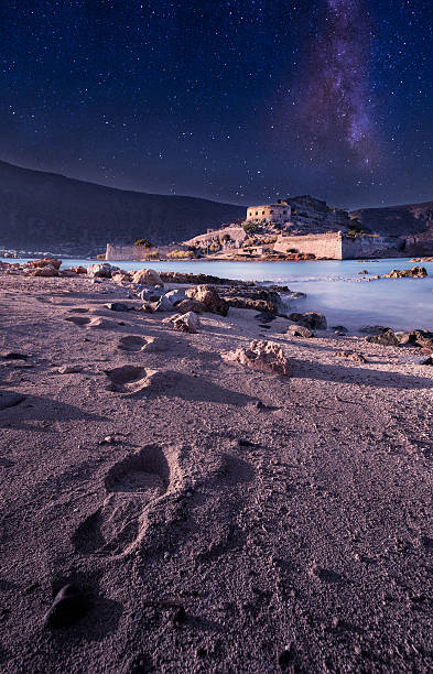 Trails on the sand under moonlight. Trails on the sand, driving to the fortress of Spinalonga, an island where were isolated lepers. Here took place the story of Victoria 's Hislop novel "The Island". Before that it was used as a fortress from Venetian and Turks. moonland stock pictures, royalty-free photos & images