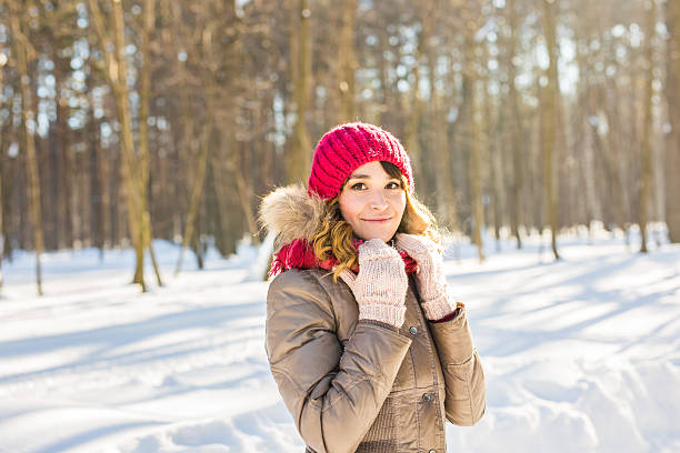 istock Winter woman in snow looking at camera outside on snowing 617879108