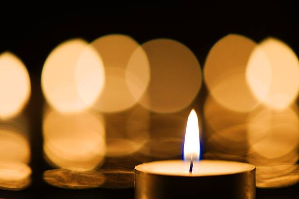 istock Burning candle with beautiful bokeh background 617879420