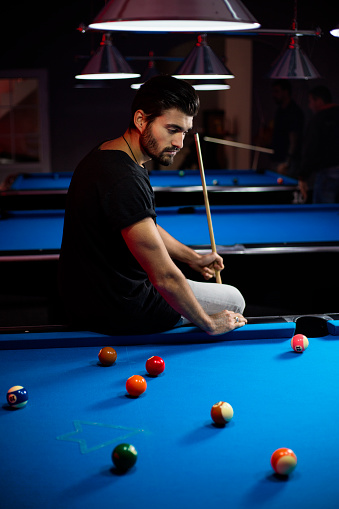 Man At Pool Table Man Sitting On A Pool Table Stock Photo - Download Image Now - Adult ...
