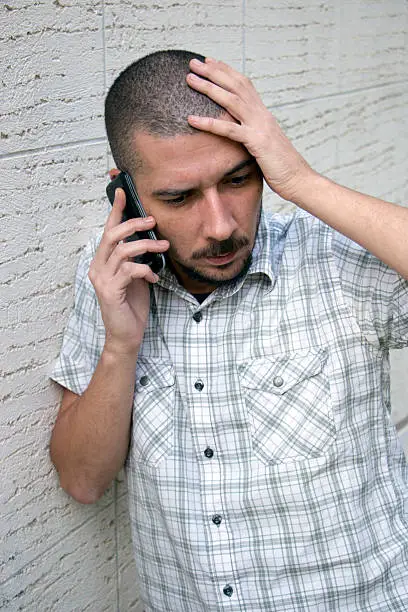 Photo of Young man talking on the phone to waive the head
