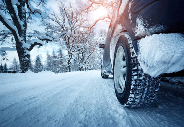 istock Car tires on winter road 617881226