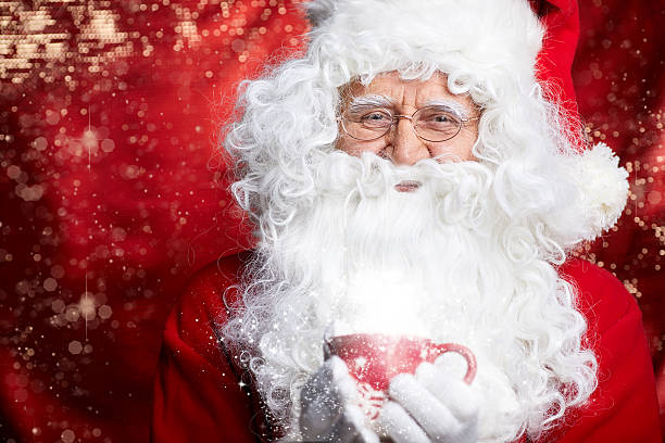 istock Santa Claus drinking tea Closeup Portrait Isolated on red 617881456