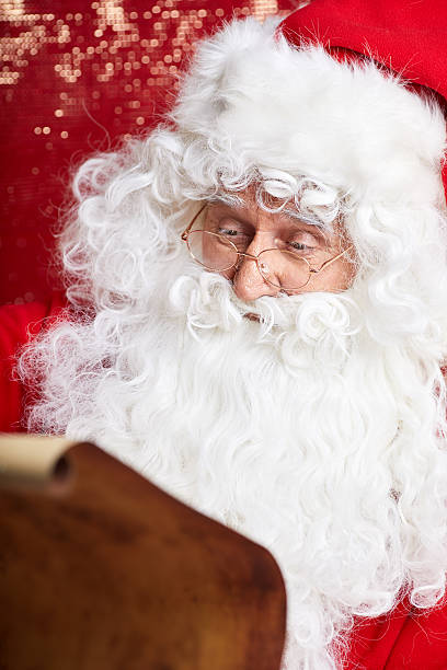 istock Checking his special list. Traditional Santa Claus sitting 617881580