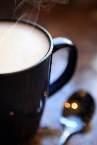 hot mug of cappuccino with spoon, close up - latté cafe macchiato cappuccino cocoa imagens e fotografias de stock