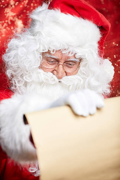 istock Checking his special list. Traditional Santa Claus sitting 617881748