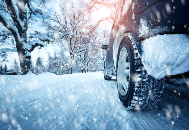 istock Car tires on winter road 617881790