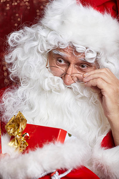 istock Santa Claus drinking tea Closeup Portrait Isolated on red 617881932
