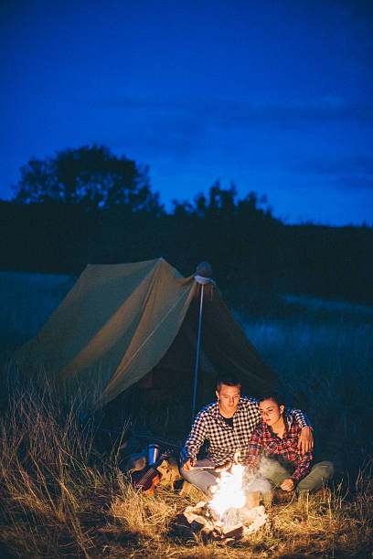 istock Couple preparing sausages on bonfire 617882150
