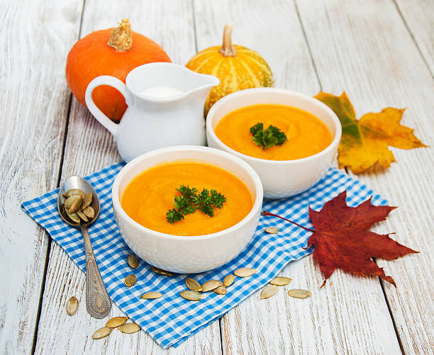 istock Pumpkin soup with fresh pumpkins 617882408