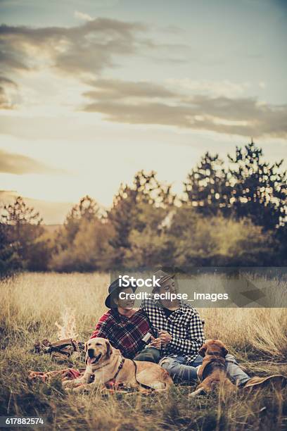 Couple Drinking Tea In Front Of Bonfire Stock Photo - Download Image Now - Couple - Relationship, Grass, Adult