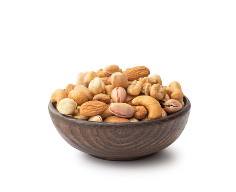 Mix nuts with wooden bowl , isolated on white