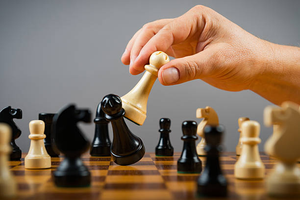 istock chess white queen hit black queen 617882916