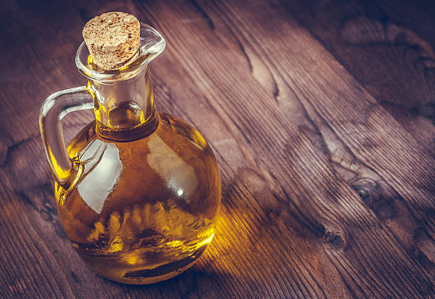 istock olive oil container bottle with stopper on wood table background 617883680