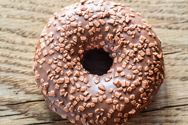 istock Chocolate donut on the wooden background 617884334