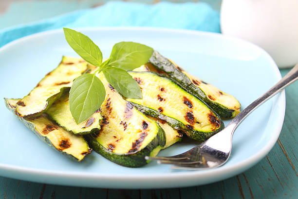 istock zucchini grilled on a blue plate with basil, selective focus. 617885642