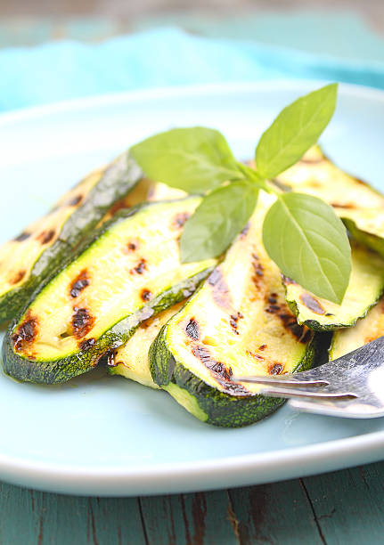 istock zucchini grilled on a blue plate with basil, selective focus. 617885686