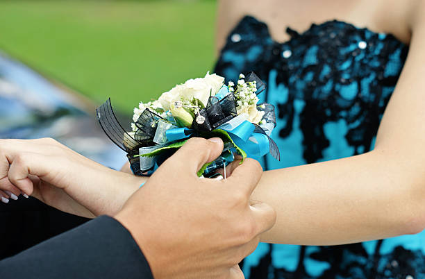 istock girl gets corsage 617886022