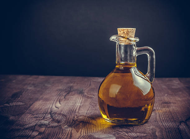 istock olive oil container bottle with stopper on wood table background 617887424