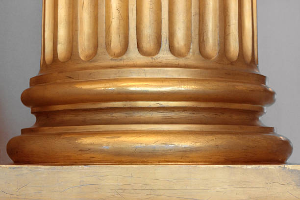 istock Lower part of gilded fluted Doric column 617887762