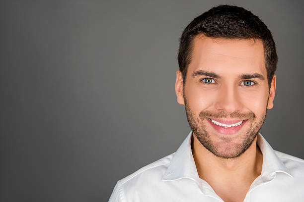 istock cheerfull man in white shirt 617892070