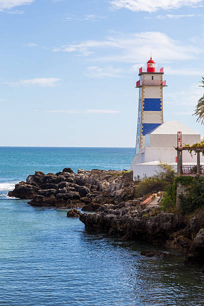 istock lighthouse on ocean coast in bay cascais 617892784