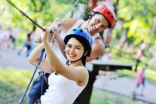 istock boy and girl climbing on rope road 617892892